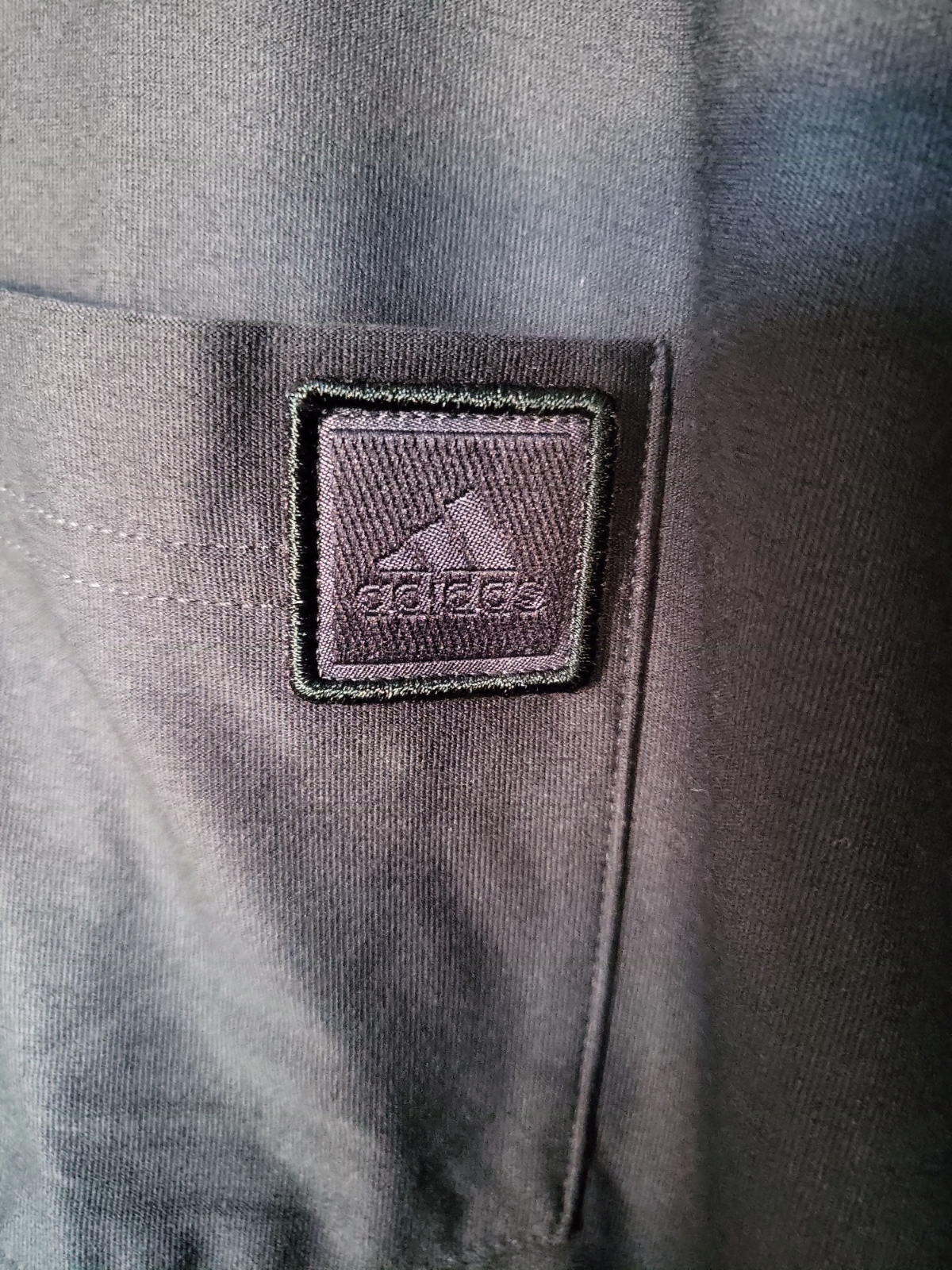 Black designer men's shirt with textured logo patch detail, luxury pre-loved clothing