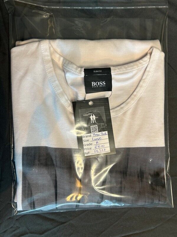Folded Hugo Boss men’s T-shirt in plastic packaging with tag, large size, white and black color