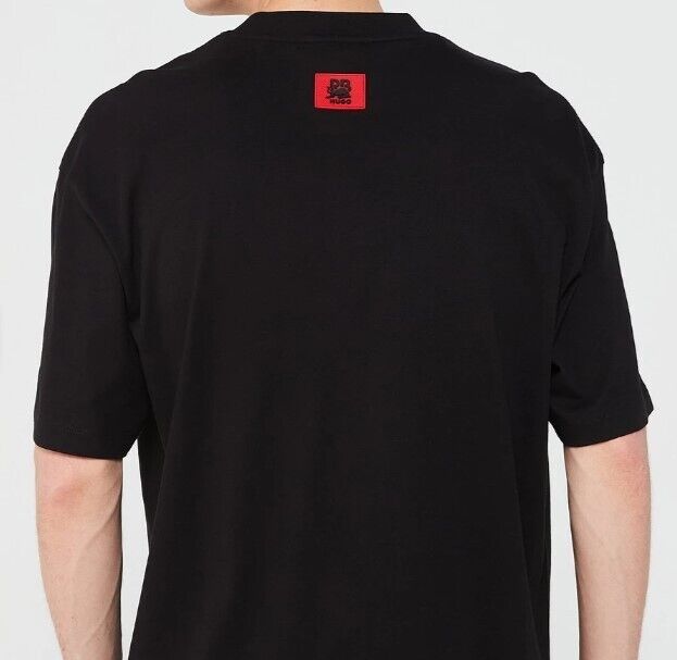 Back view of a black designer t-shirt with a red logo patch on the upper back