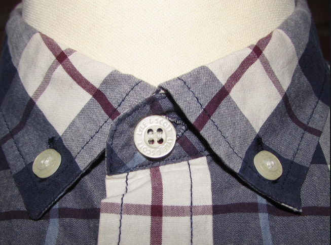 Close-up of men's checkered shirt collar with button-down details