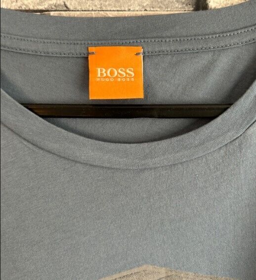 Grey designer crew neck t-shirt with visible orange BOSS Hugo Boss label on hanger