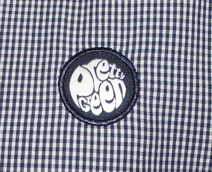 Blue and white checkered shirt with embroidered round patch logo