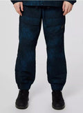 Men's dark blue patterned cargo pants with elastic cuffs, front pockets, and black sneakers