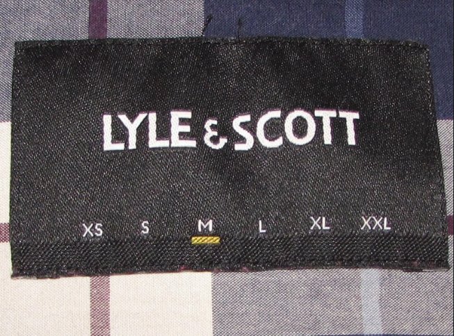 Lyle & Scott clothing label showing size options on a plaid fabric background