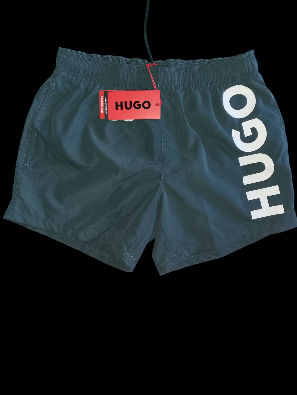 Men's black designer swim shorts with white HUGO logo and elastic waistband